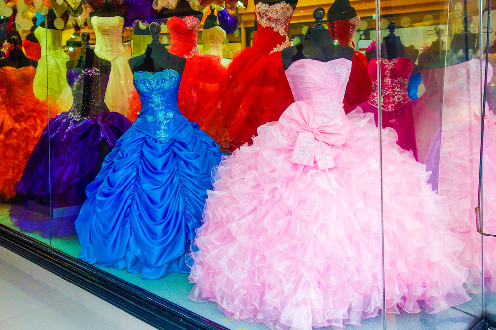 Why is the creation of the Quinceanera dress a factor in the cost
